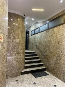 a staircase in a building with stone walls at Ryokan in São Paulo +22 photos