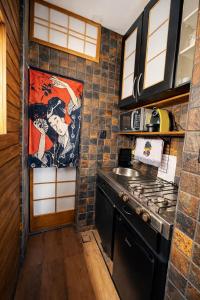 a kitchen with a sink and a stove at Ryokan in São Paulo
