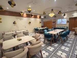a restaurant with tables and chairs in a room at Hotel Mikado Palace in Gurgaon +20 photos