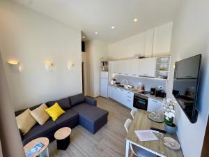 a living room and kitchen with a couch and a table at Ano Syros Orient in Ano Syros