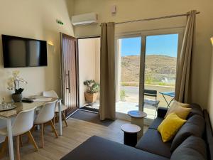 a living room with a couch and a table and a dining room at Ano Syros Orient in Ano Syros