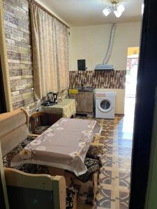 a room with a table and a washing machine at Matevosyans Guest House in Goris