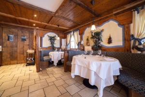 a dining room with two tables in a restaurant at Nivis Hotel in Folgarida