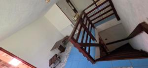 a wooden staircase in a room with blue tiles at Cabana Cerbu in Bozovici +32 photos
