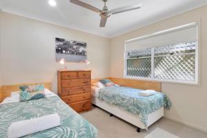 a bedroom with two beds and a window at Flip Flop Inn in Amity Point