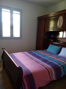 a bedroom with a large bed and a window at La simonde in Malarce-sur-la-Thines