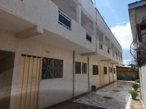 a building with doors and windows on the side of it at Residence samy in San-Pédro