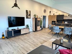 a living room with a large flat screen tv at LuxLife - Panorama Bergblick, Sauna, Balkon, Luxus Pur in Buchenberg
