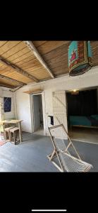 a room with a chair and a table in a building at Les Chambres d'Umoja in Grand-Bourg