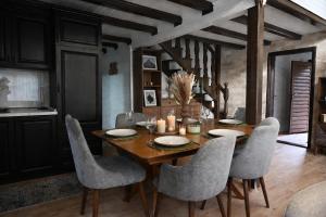 a dining room with a wooden table and chairs at North Forest in Žabljak