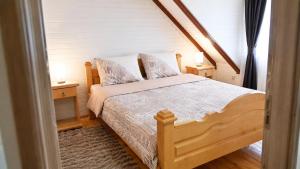 a bedroom with a wooden bed and two night stands at North Forest in Žabljak