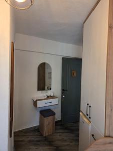 a bathroom with a sink and a green door at CARETTA PANSİYOn in Kaş