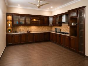 a large kitchen with wooden cabinets and a ceiling at Guest Villa in Lāsezai