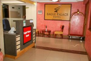 a lobby of a hotel with a cash register and a table at Eagle Palace Hotel in Nakuru