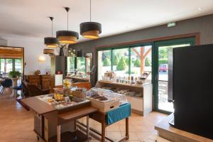 a kitchen with a table with food on it at L'Oustal de Vézac in Vézac
