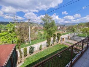 a balcony with a view of a yard with trees at Apartman Bistrivoda 2 in Vogošća