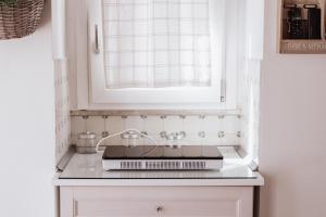 a kitchen counter with a sink and a window at A L Tourist House - La Corte di Cavuor in Monopoli