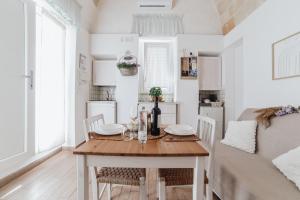 a kitchen and dining room with a table and chairs at A L Tourist House - La Corte di Cavuor in Monopoli +9 photos