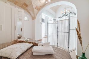 a bedroom with a large bed in a room at A L Tourist House - La Corte di Cavuor in Monopoli