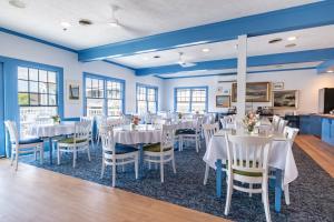 a dining room with tables and chairs and blue walls at The Sparhawk Oceanfront Resort in Ogunquit