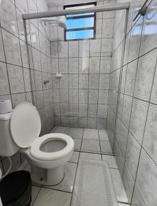 a small bathroom with a toilet and a window at Pousada Oceano Azul in Guarapari +39 photos