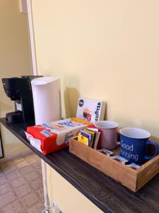 a counter with coffee cups and other items on it at Suite la Ficara in Bovalino Marina