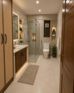 a bathroom with a shower and a toilet and a sink at Guest Villa in Lāsezai