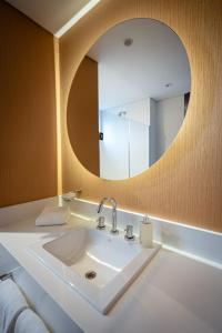 a bathroom with a sink and a mirror at Dazzler by Wyndham Salta in Salta
