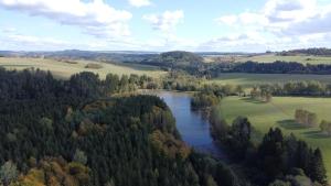 an aerial view of a river in a field at Nature Center Údolí volavek II in Weseritz