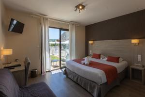 a hotel room with a large bed and a window at L'Oustal de Vézac in Vézac +57 photos