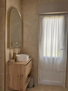 a bathroom with a sink and a mirror at La Folie Blanche in Vertou +25 photos