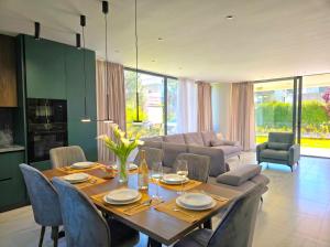 a dining room with a table and chairs at Azure Garden Villa 317 in Lalzit Bay