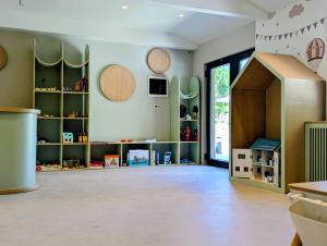 a room with green walls and a large doorway at AMZA Valbona Mountain Retreat in Valbonë