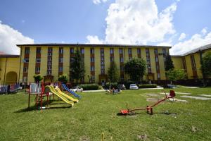 a playground in front of a large building at Mural Art Apartament in Petroşani