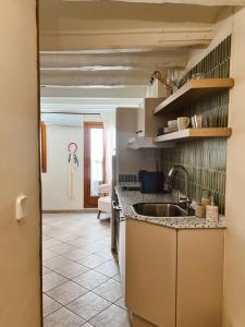 a kitchen with a sink and a counter top at Tu mejor estadia en Tarragona centro in Tarragona +8 photos