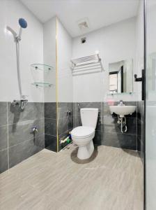 a bathroom with a toilet and a sink at Ahmed Rifan Hotel in Kulhudhuffushi