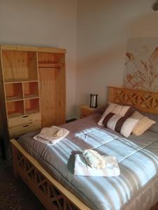 a bedroom with a large bed with two towels on it at Villa Valeria in General Acha