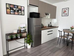 a kitchen with a stainless steel refrigerator and a table at PlatanHome 12 in Lenti +7 photos