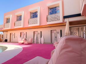 a room with a purple carpet and a pool at On Pink Motel in Matalascañas