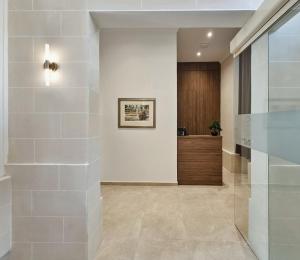 a lobby with a hallway with white walls at Casa Lina Suites in Sliema