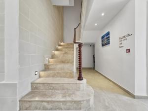 a staircase in a room with white walls and a stair case at Casa Lina Suites in Sliema +20 photos
