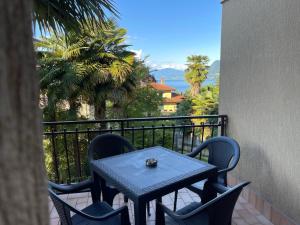 a table and chairs on a balcony with a view at Fior di Luna in Stresa
