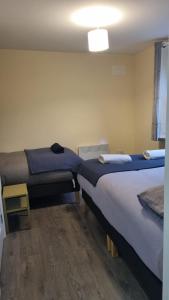a room with two beds in a room at Cosy Condo near City & Airport in Dublin
