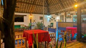 a restaurant with a table and chairs and a red table cloth at Suarez Hotel in Antsiranana