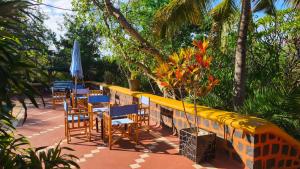 a row of tables and chairs with an umbrella at Suarez Hotel in Antsiranana