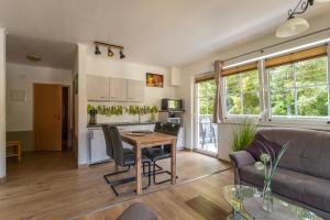 a living room with a couch and a table at Ferienanlage Zum Wildbach Schierke in Schierke