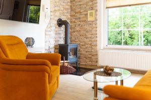a living room with a couch and a fire place at Ferienanlage Zum Wildbach Schierke in Schierke