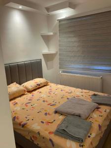 a bedroom with a large bed with flowers on it at Relax Apratman in Gornji Milanovac