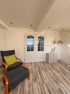 a living room with a chair and a table at Apartmán Bílé Karpaty in Strání