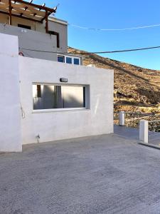 a building with a large window on the side of it at Aether Studio Ano Syros in Ano Syros